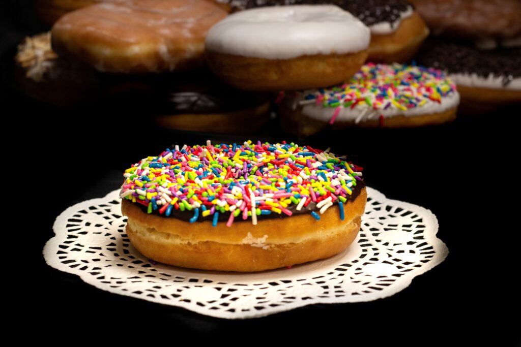 Chocolate Iced Raised Ring Donuts with Rainbow Jimmies