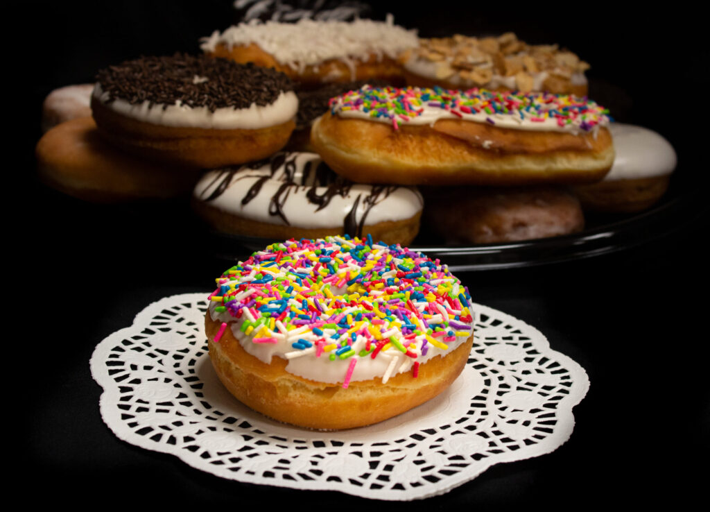 Iced Raised Ring Donuts with Rainbow Jimmies