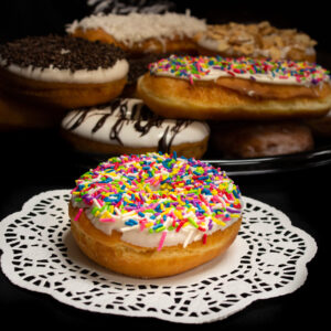 Iced Raised Ring Donuts with Rainbow Jimmies